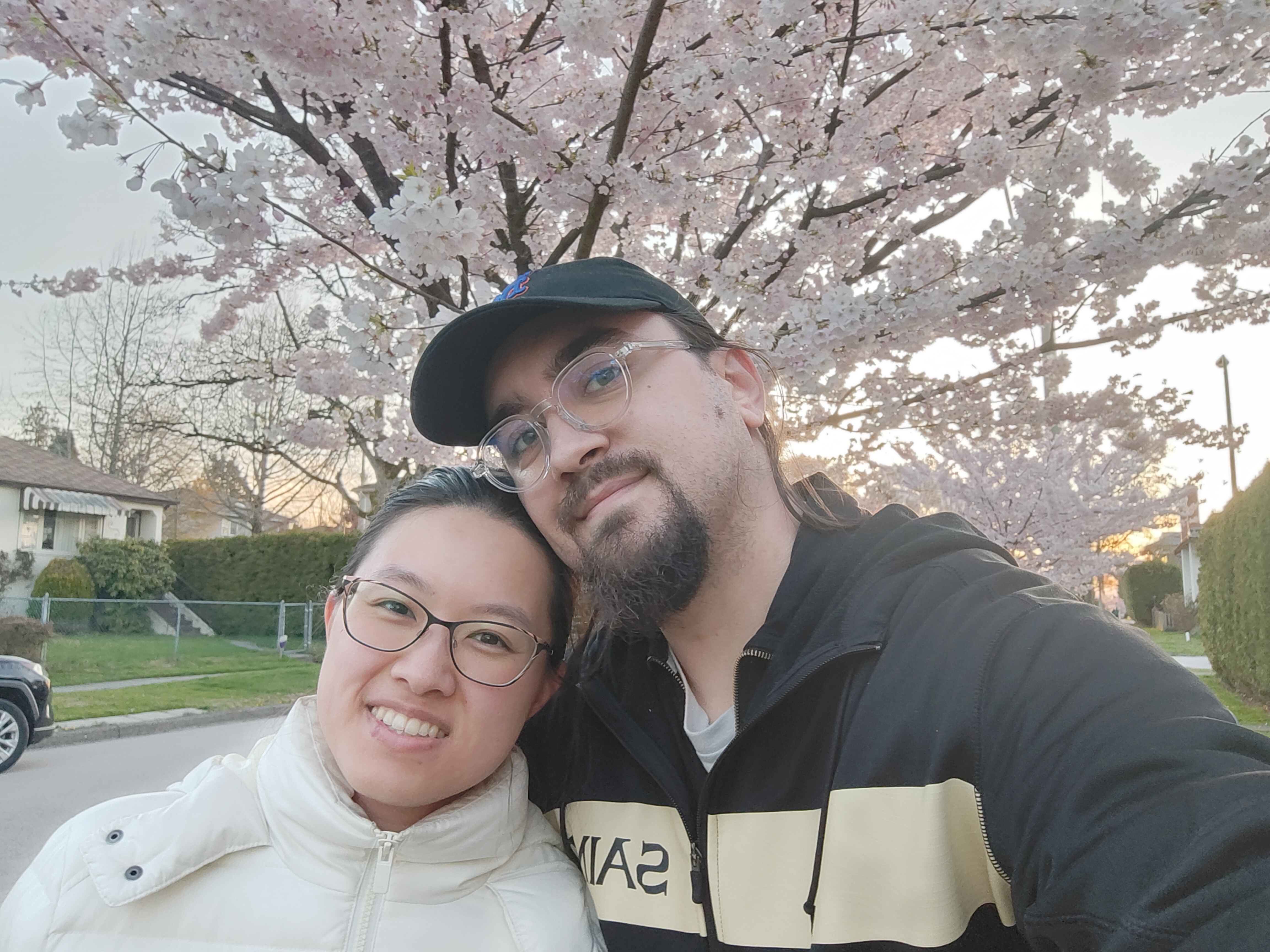 Megan and Andrew under a cherry blossom tree in Vancouver